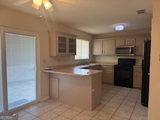 120 Mossydale Lane Albany, GA 31721 - Photo 9 of 20 a kitchen with kitchen island granite countertop a sink cabinets and stainless steel appliances