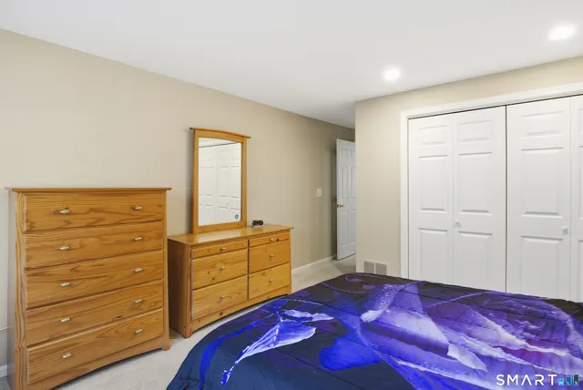 a bedroom with a bed and a dresser