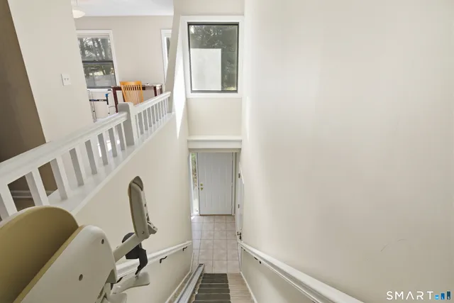 a view of a hallway with workspace and wooden floor