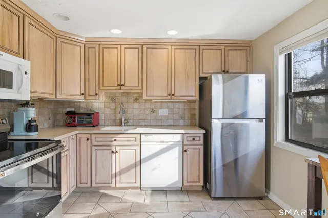 a kitchen with cabinets and stainless steel appliances