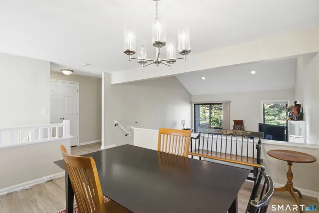 a view of a dining room with furniture and a chandelier