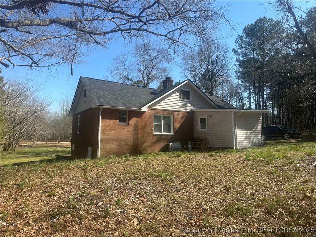 33 Alberta Lane Cameron, NC 28326 - Photo 2 of 14 a house that is sitting in the middle of a field