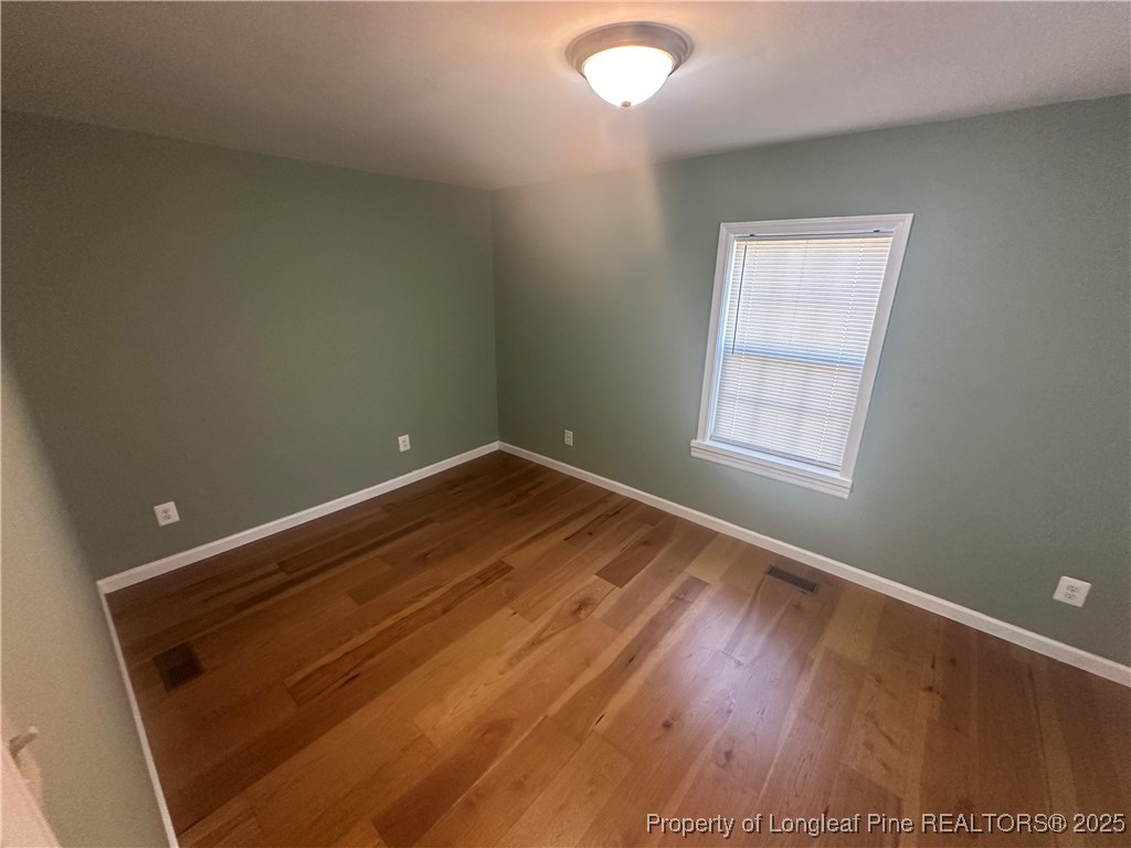 33 Alberta Lane Cameron, NC 28326 - Photo 6 of 14 an empty room with wooden floor and windows