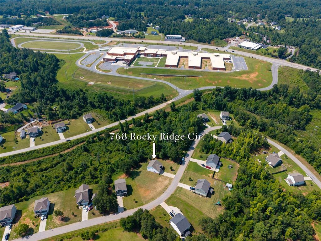 768 Rocky Ridge Circle Seneca, SC 29678 - Photo 24 of 30 An aerial perspective reveals a neighborhood setting with verdant surroundings, and a distant school campus.