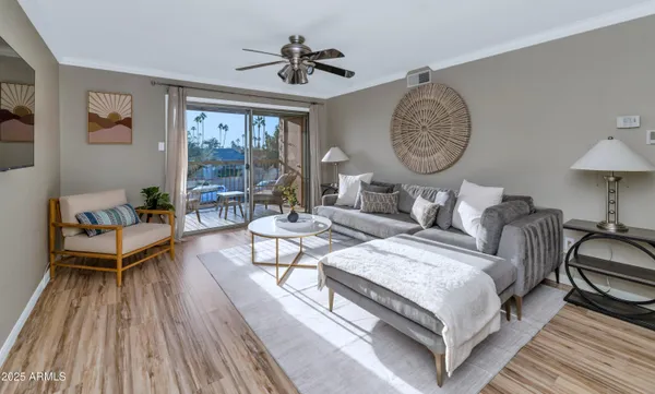 a living room with furniture a clock on wall and a window