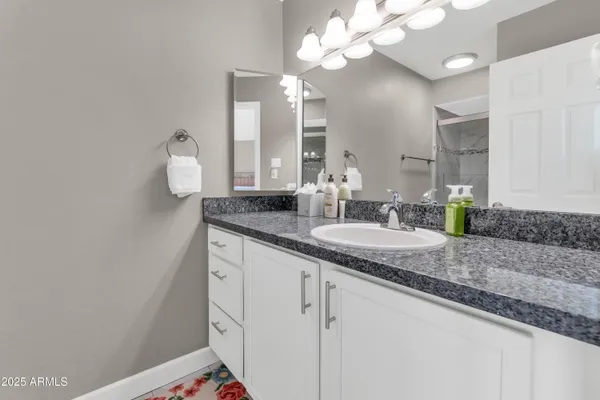 a bathroom with a double vanity sink and a mirror