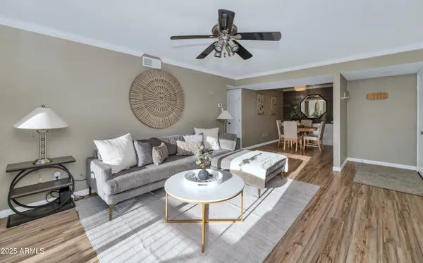 a living room with furniture and a wooden floor