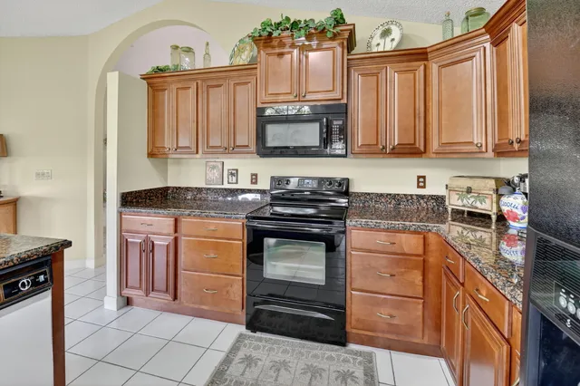 a living room with furniture a chandelier and a flat screen tv
