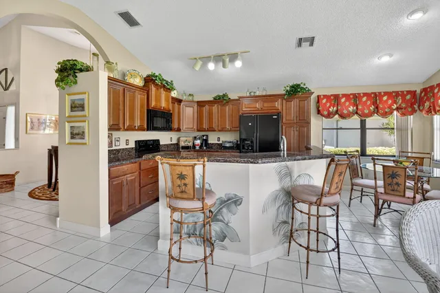 a living room with furniture a chandelier and a large window