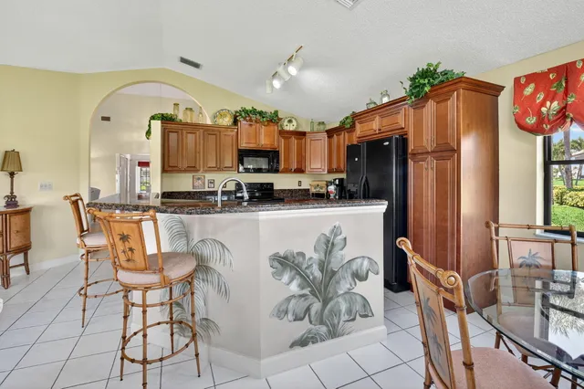 a kitchen with stainless steel appliances granite countertop a stove and a sink
