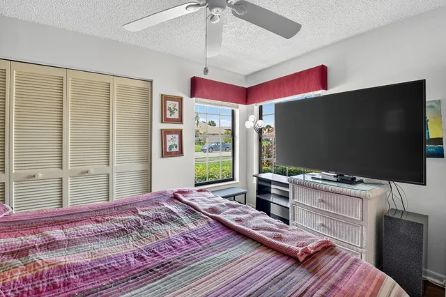 an aerial view of a house with a garden and lake view