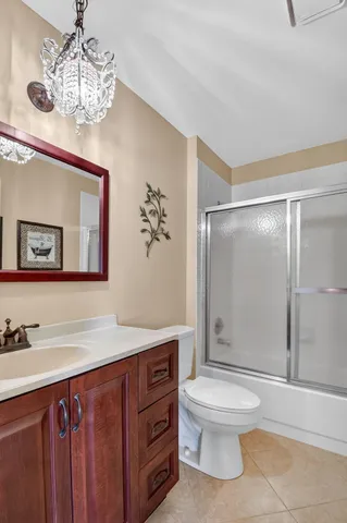 a front view of a house with a yard and potted plants