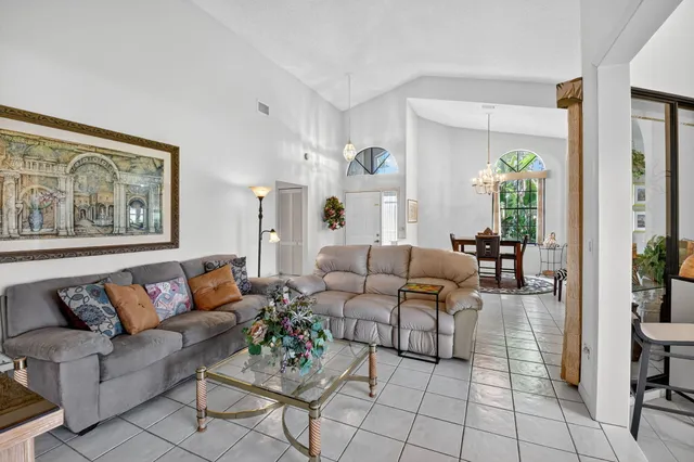 an aerial view of a house with a garden and lake view