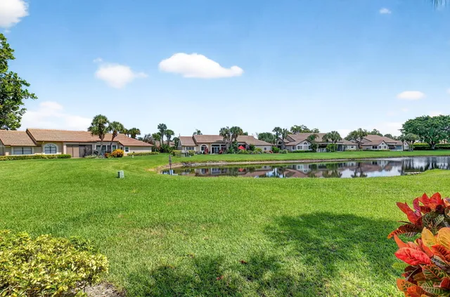 an aerial view of a house with outdoor space and lake view