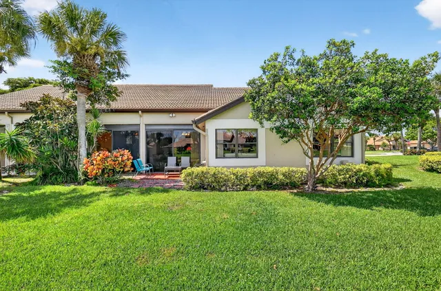 an aerial view of a house with a garden and swimming pool