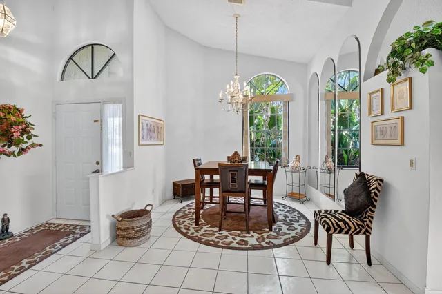 a living room with furniture a flat screen tv and a floor to ceiling window