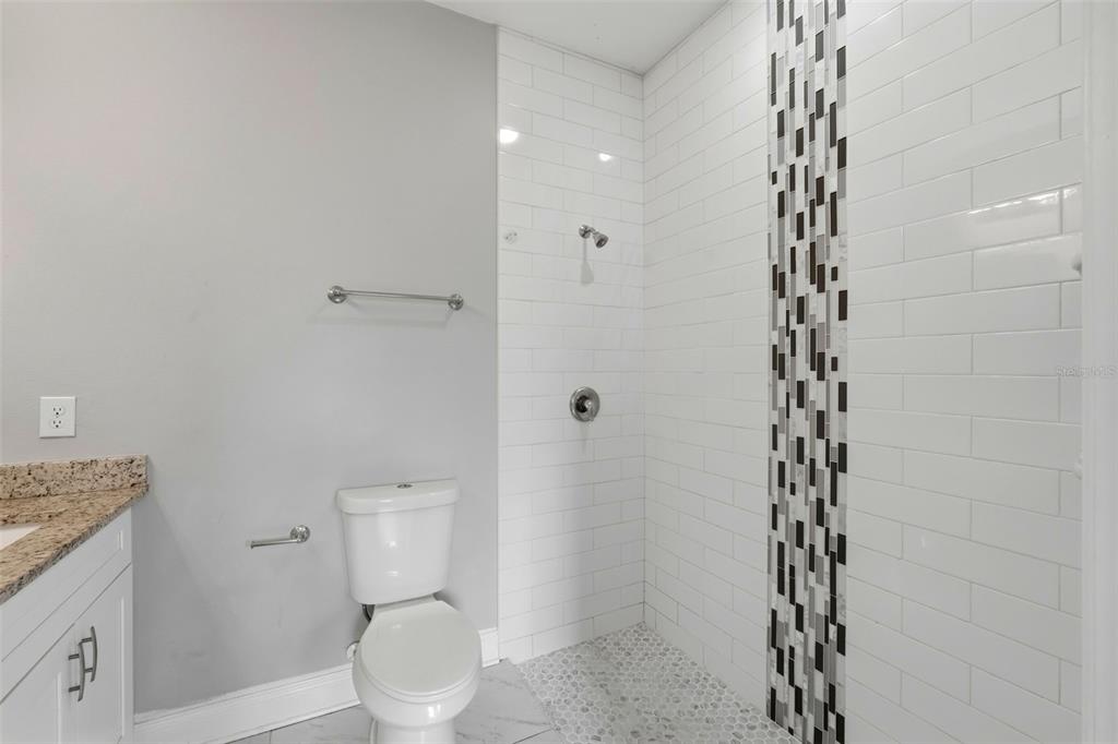314 Colonade Court, Unit A Kissimmee, FL 34758 - Photo 11 of 24 a bathroom with a toilet and a shower