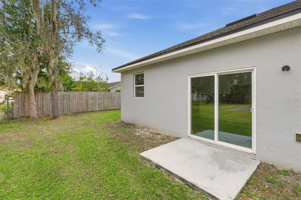 314 Colonade Court, Unit A Kissimmee, FL 34758 - Photo 15 of 24 a view of backyard with large trees and wooden fence