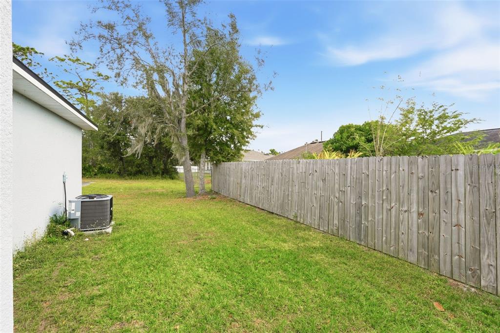 314 Colonade Court, Unit A Kissimmee, FL 34758 - Photo 18 of 24 a view of a backyard with a tree
