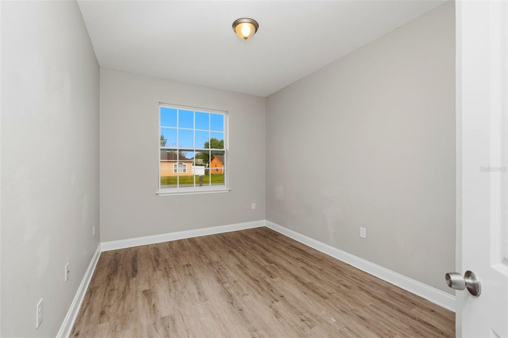 314 Colonade Court, Unit A Kissimmee, FL 34758 - Photo 19 of 24 a view of room with hardwood floor and window