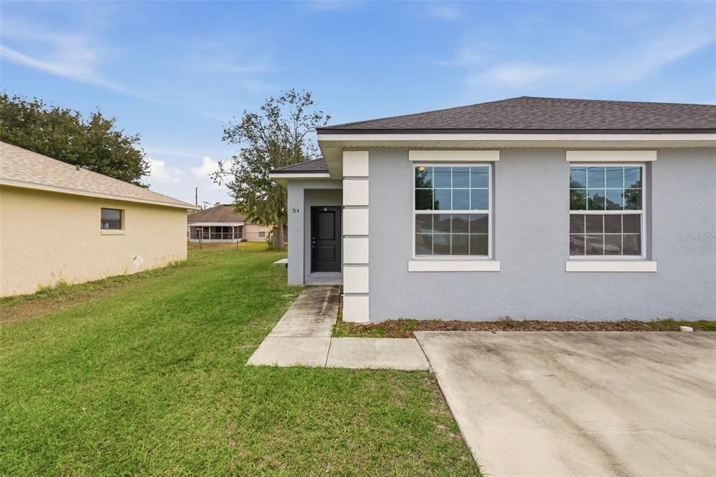 314 Colonade Court, Unit A Kissimmee, FL 34758 - Photo 3 of 24 front view of house with a yard