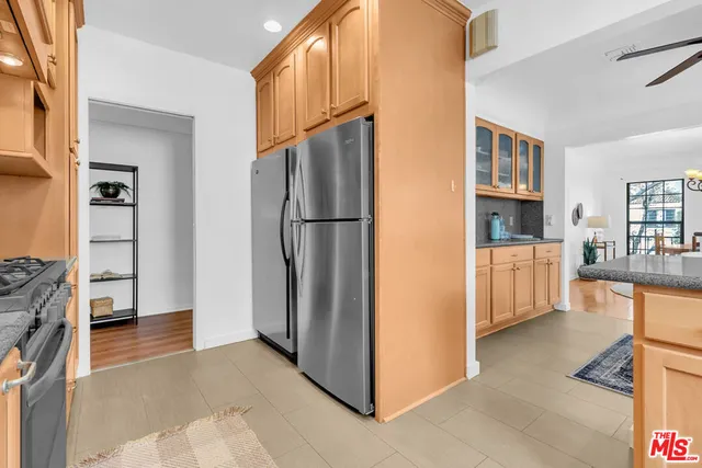 a view of kitchen with furniture and refrigerator