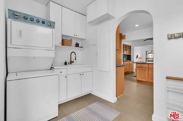 a kitchen with cabinets and a refrigerator