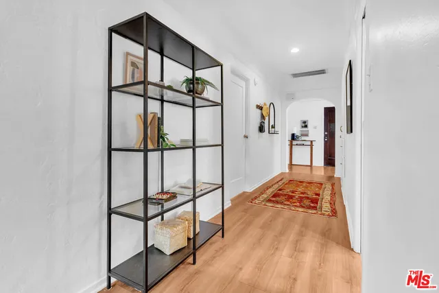 a view of hallway with a large window and a rug