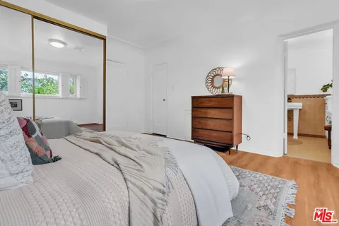 a bedroom with a bed and a dresser