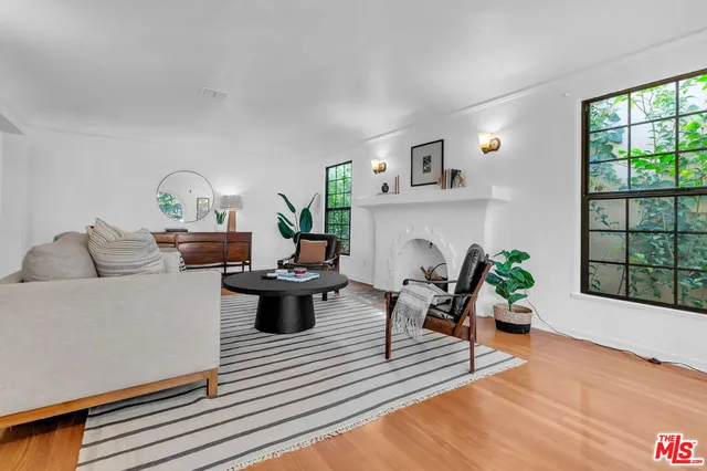 a living room with furniture and a potted plant
