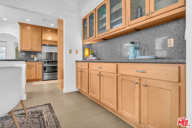 a kitchen with stainless steel appliances granite countertop a stove and a sink