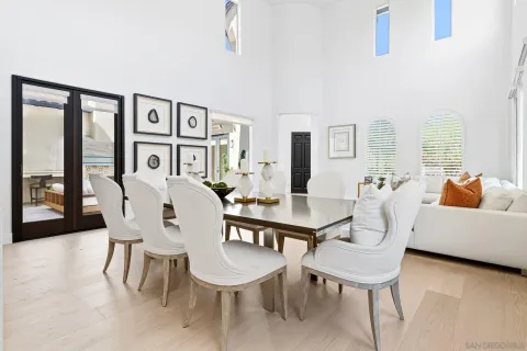 a living room with dining room and wooden floor