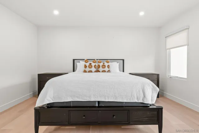 a living room with furniture a large window and a bookshelf