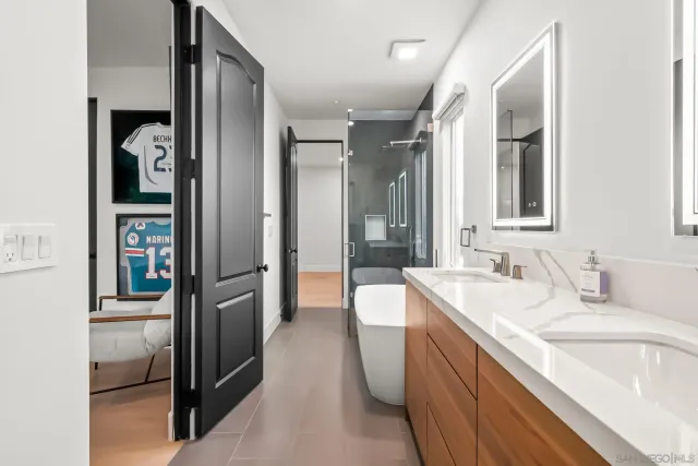 a front view of a house with a yard and potted plants