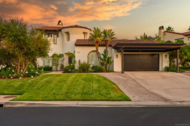 a view of a patio with couches table and chairs and potted plants