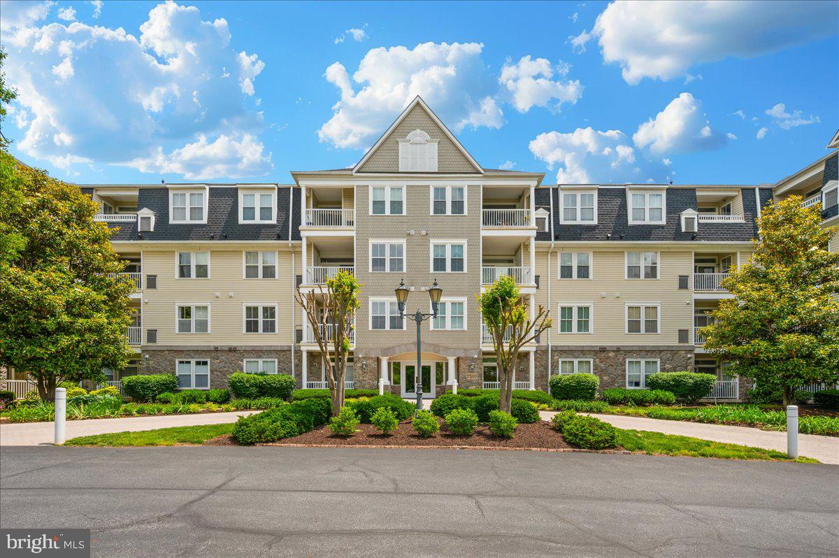 a front view of a residential apartment building with a yard
