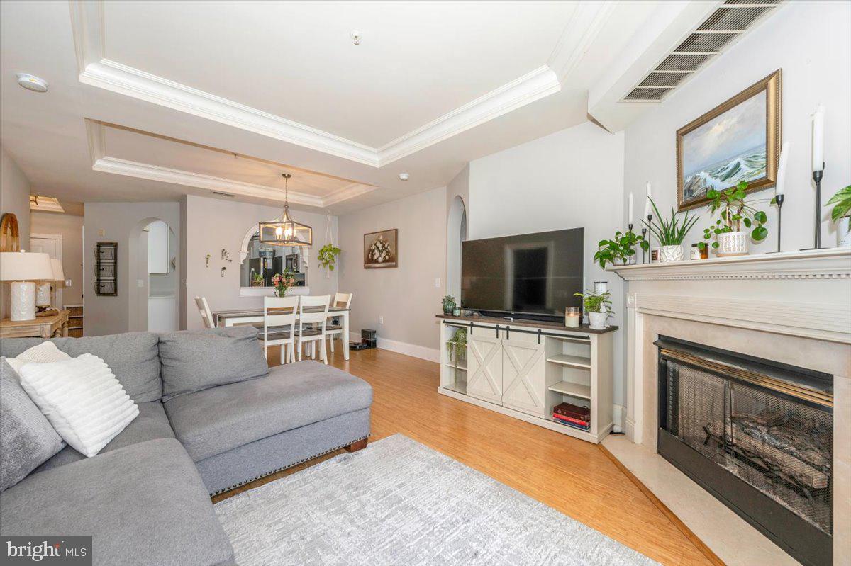 2500 Waterside Drive, Unit 110 Frederick, MD 21701 - Photo 18 of 106 a living room with furniture a flat screen tv and a fireplace