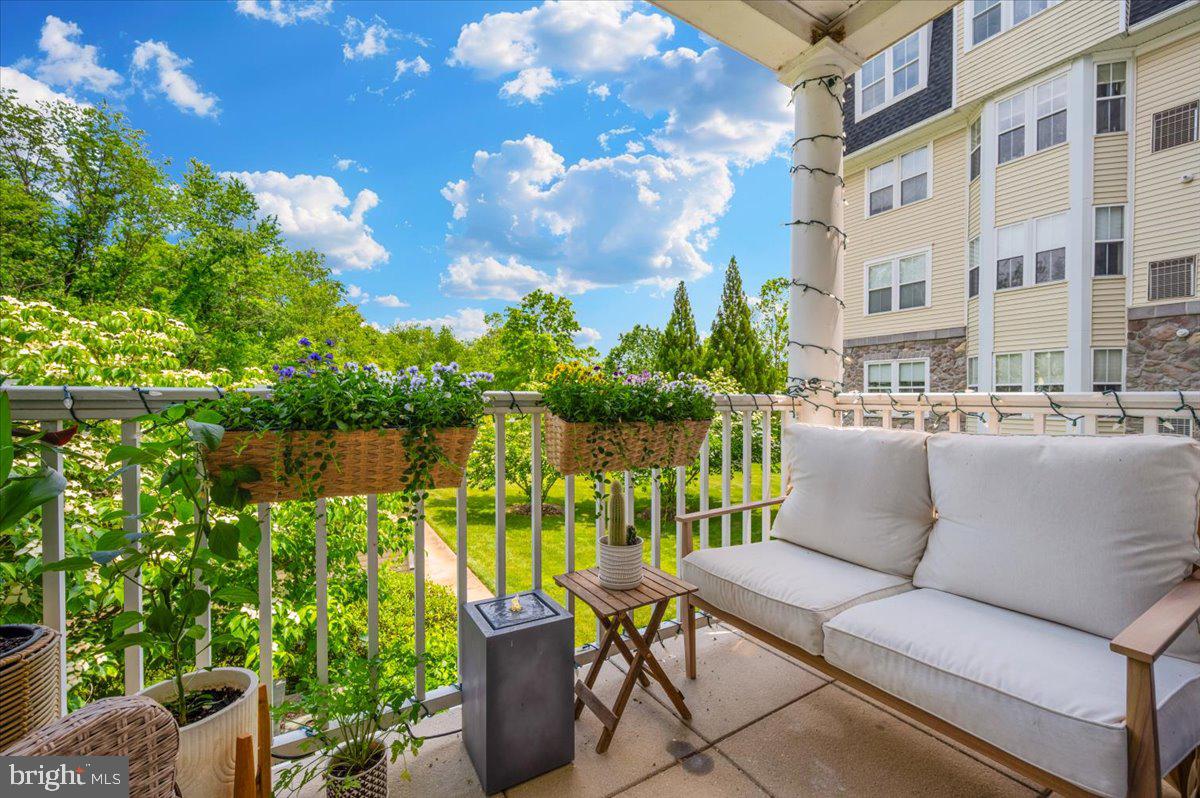 2500 Waterside Drive, Unit 110 Frederick, MD 21701 - Photo 20 of 106 a view of a patio with couches chairs potted plants and lake view