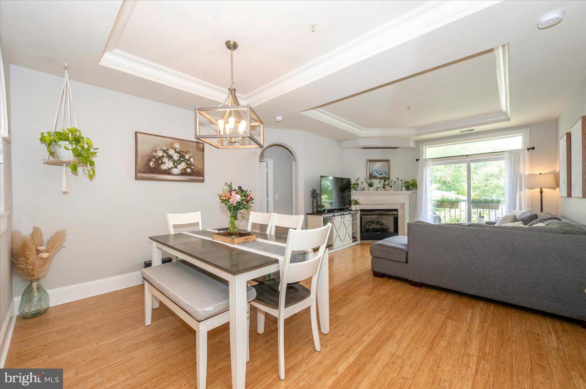 2500 Waterside Drive, Unit 110 Frederick, MD 21701 - Photo 21 of 106 a view of a dining room with furniture window and wooden floor