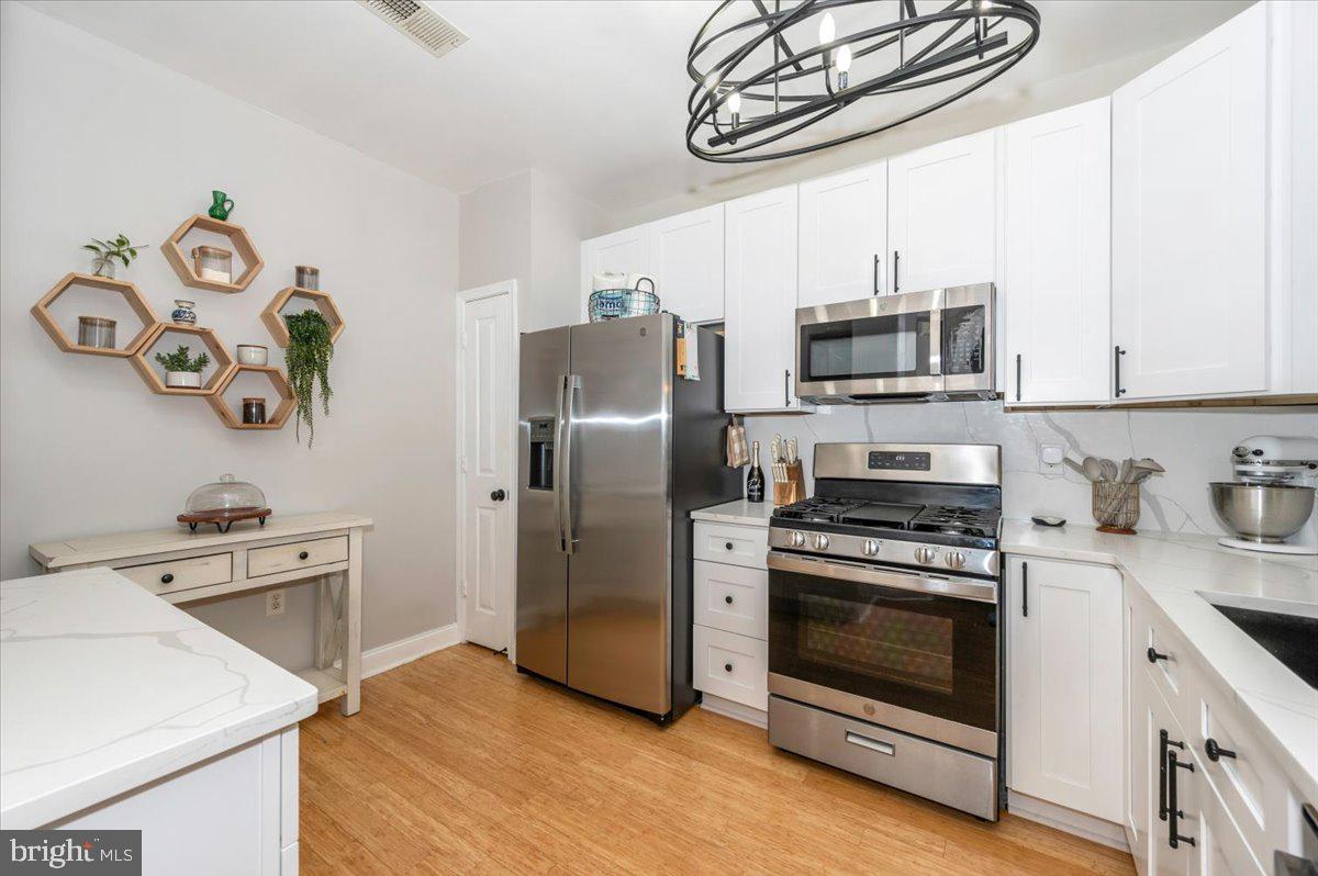 2500 Waterside Drive, Unit 110 Frederick, MD 21701 - Photo 25 of 106 a kitchen with stainless steel appliances a stove a microwave and a refrigerator