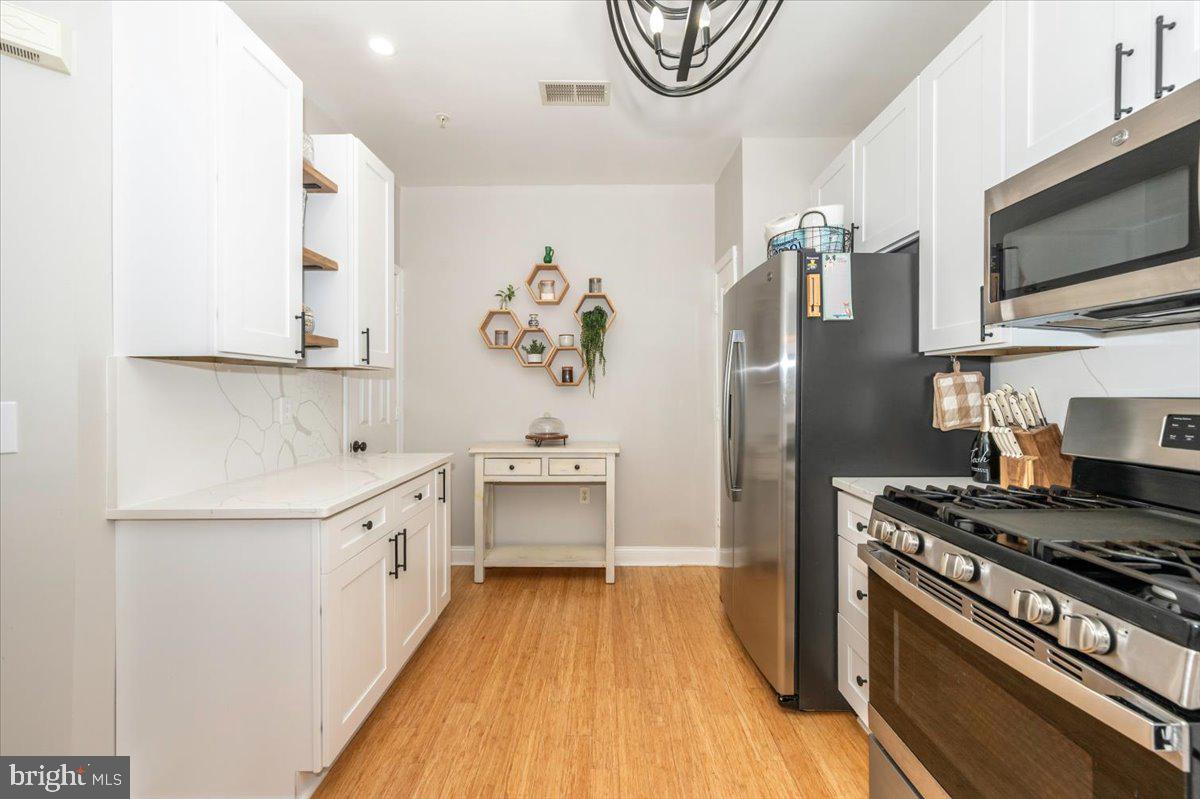 2500 Waterside Drive, Unit 110 Frederick, MD 21701 - Photo 26 of 106 a kitchen with stainless steel appliances a stove a sink and a refrigerator