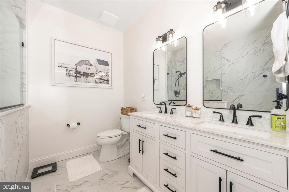 2500 Waterside Drive, Unit 110 Frederick, MD 21701 - Photo 37 of 106 a bathroom with a toilet sink and mirror