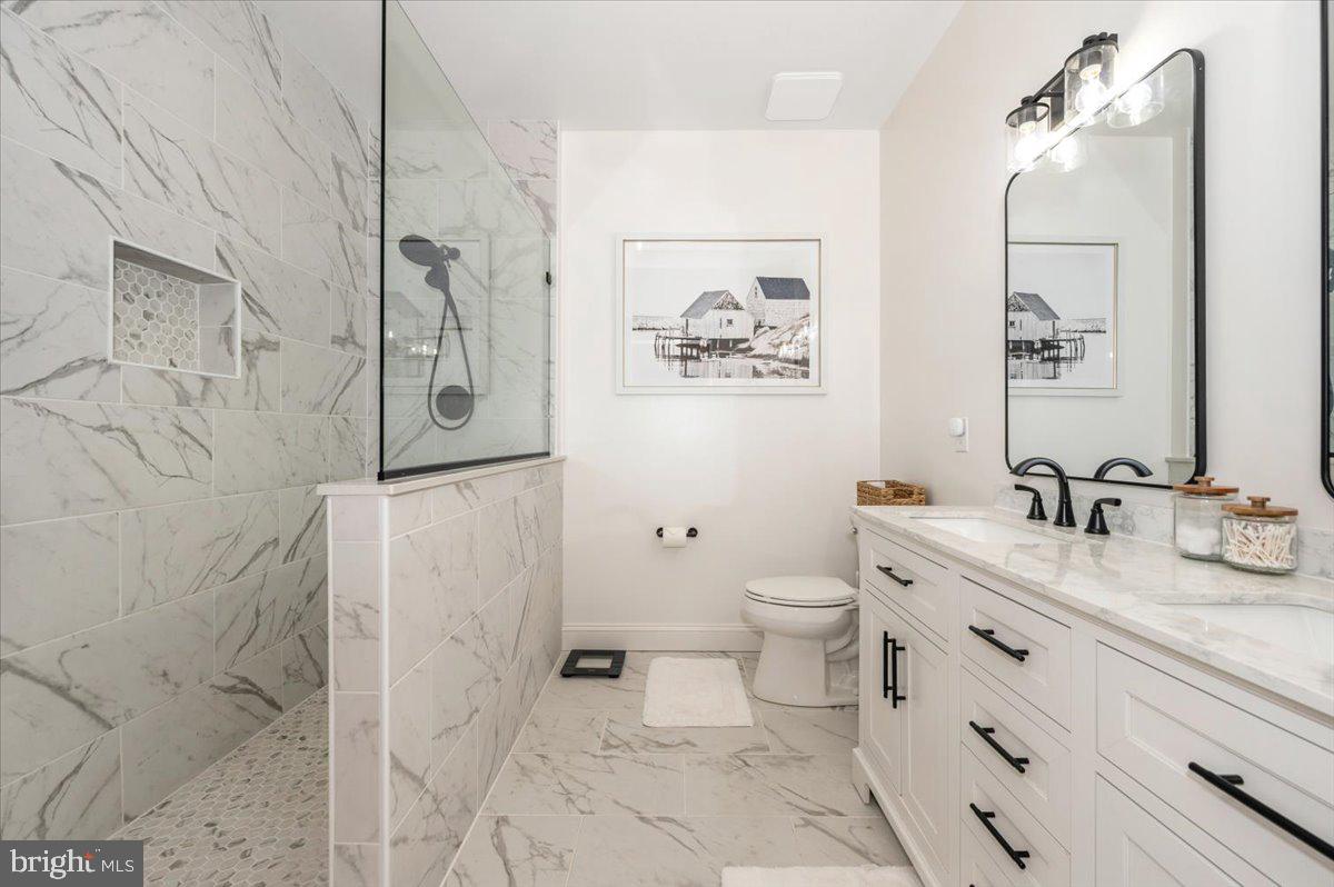 2500 Waterside Drive, Unit 110 Frederick, MD 21701 - Photo 38 of 106 a bathroom with a granite countertop sink toilet and shower
