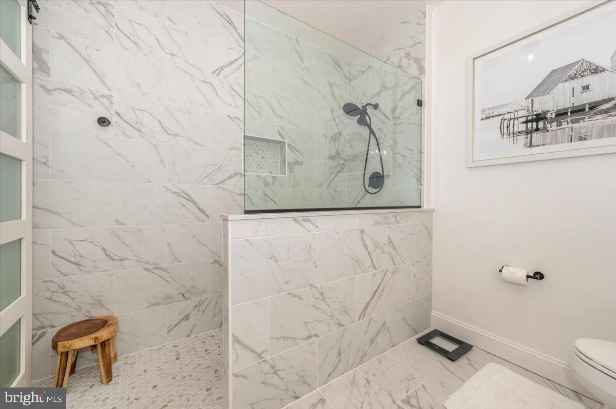 2500 Waterside Drive, Unit 110 Frederick, MD 21701 - Photo 39 of 106 a bathroom with a toilet and a shower