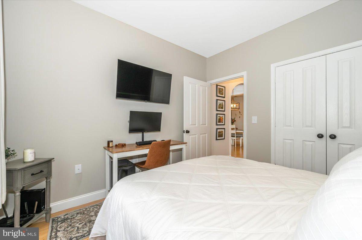 2500 Waterside Drive, Unit 110 Frederick, MD 21701 - Photo 44 of 106 a bedroom with a bed and a flat screen tv