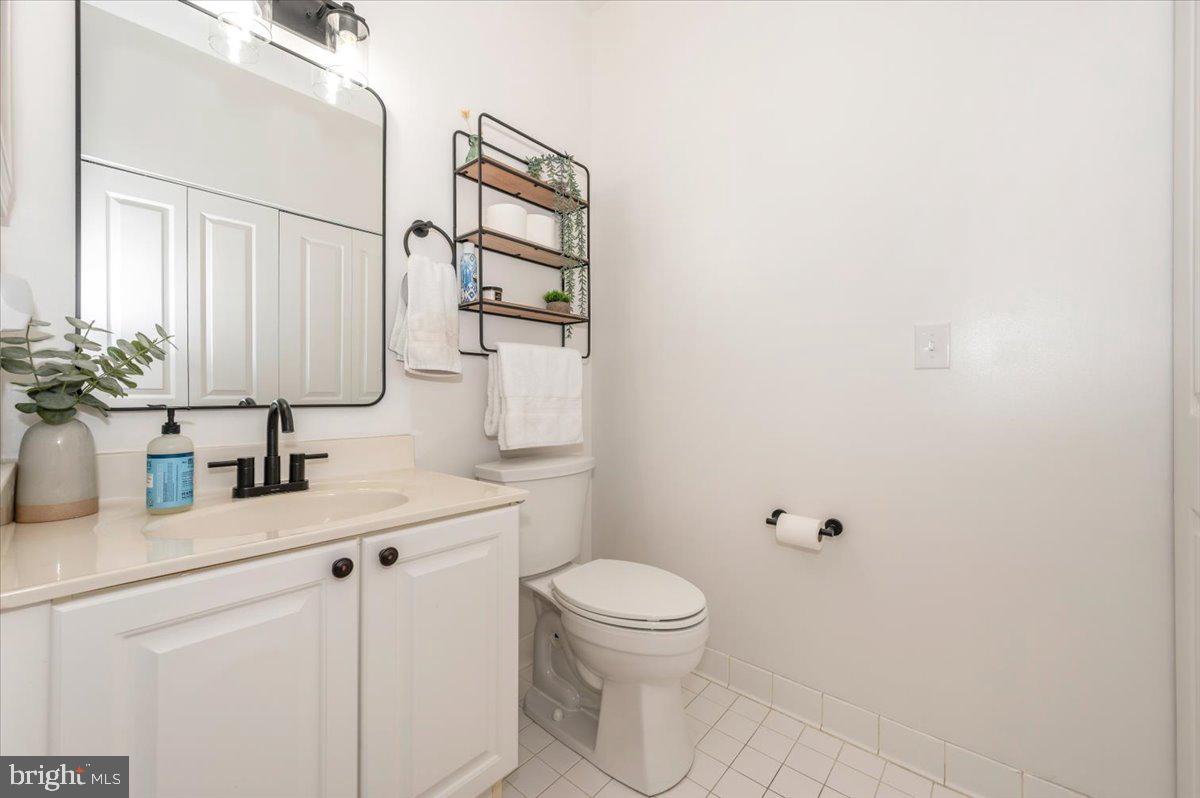 2500 Waterside Drive, Unit 110 Frederick, MD 21701 - Photo 46 of 106 a bathroom with a sink a toilet and mirror