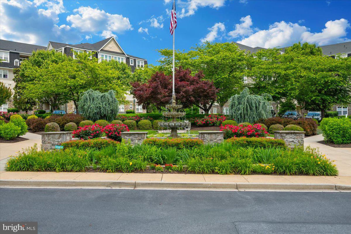2500 Waterside Drive, Unit 110 Frederick, MD 21701 - Photo 63 of 106 a backyard of a house with a garden and outdoor seating
