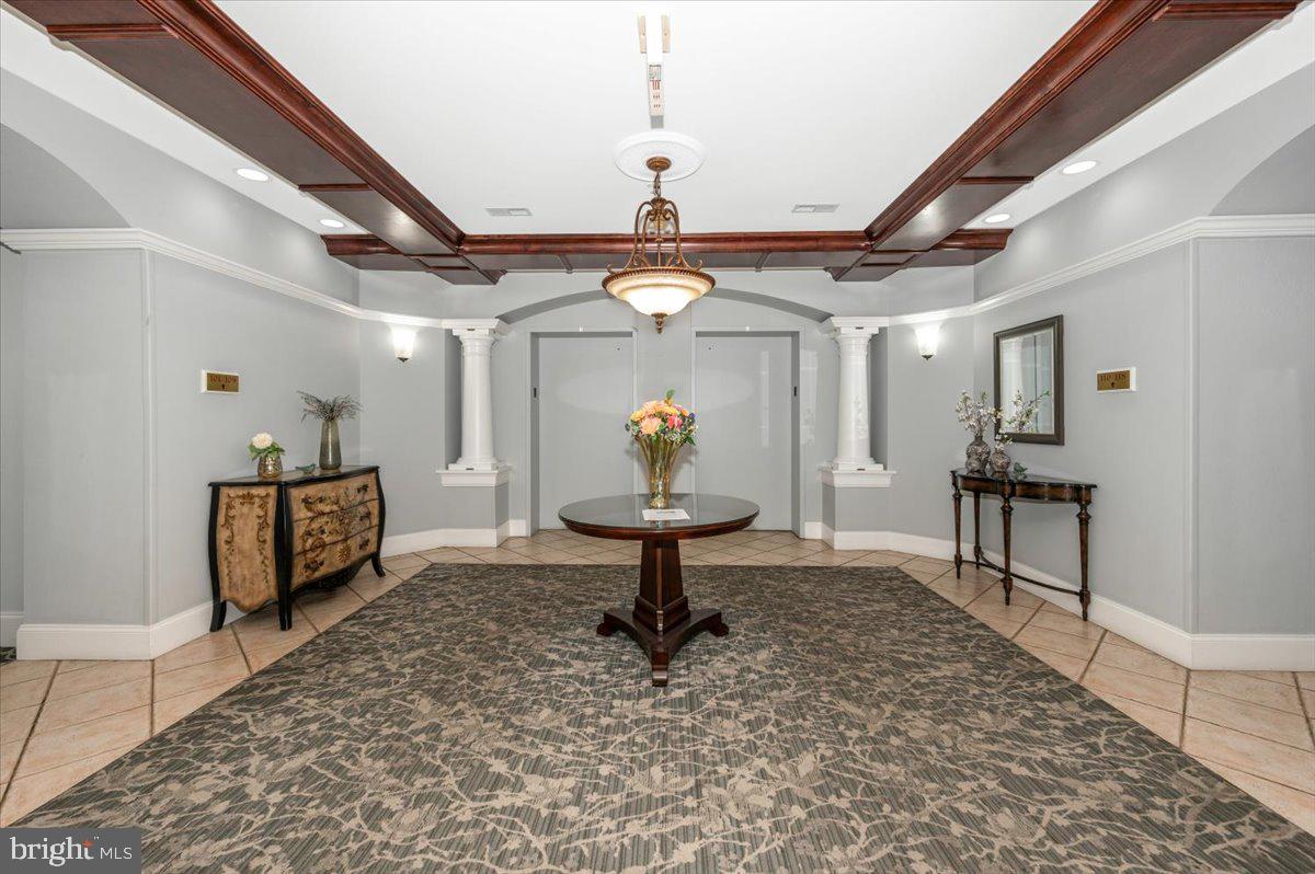 2500 Waterside Drive, Unit 110 Frederick, MD 21701 - Photo 7 of 106 a living room with lots of furniture and a chandelier