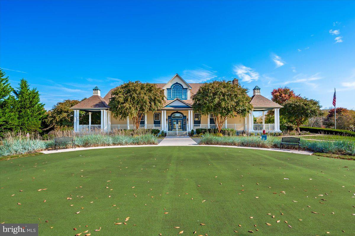 2500 Waterside Drive, Unit 110 Frederick, MD 21701 - Photo 81 of 106 a front view of house with yard and trees in the background