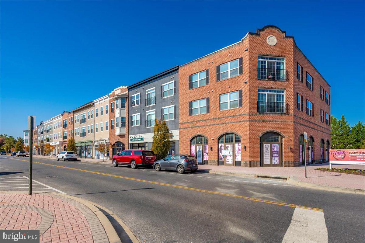 2500 Waterside Drive, Unit 110 Frederick, MD 21701 - Photo 86 of 106 a front view of multi story residential apartment building with retail shops